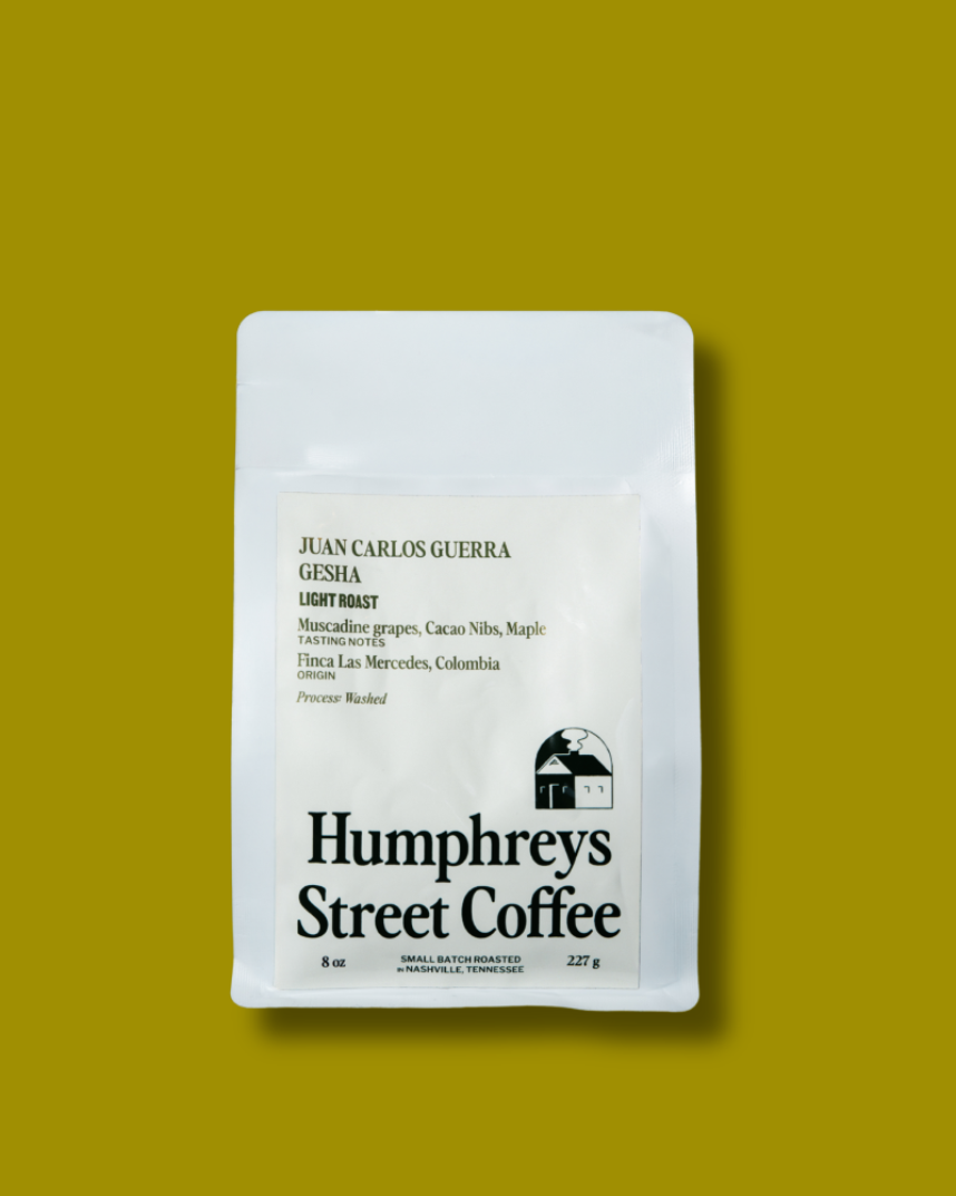 A white bag of Humphreys Street Coffee Colombian Gesha on a solid olive yellow background.
