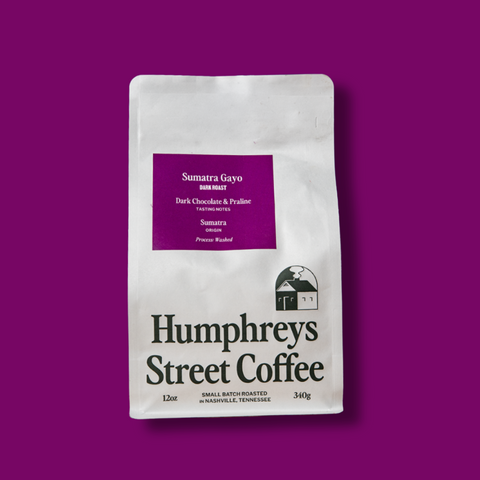 A 12 oz bag of Humphreys Street Coffee, Sumatra Gayo, displayed on a solid deep purple background.