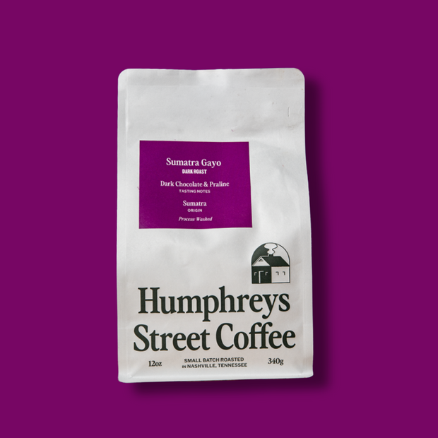 A 12 oz bag of Humphreys Street Coffee, Sumatra Gayo, displayed on a solid deep purple background.